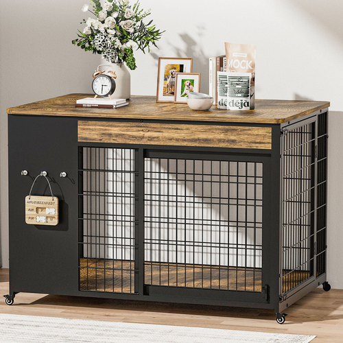 Rustic brown 42 in dog crate furniture used as a TV stand in a living room, sliding front door closed, clock and picture frames on top