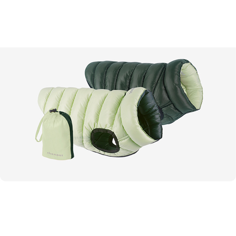 Reversible padded dog vest shown on both sides, light green and dark green, with its storage bag