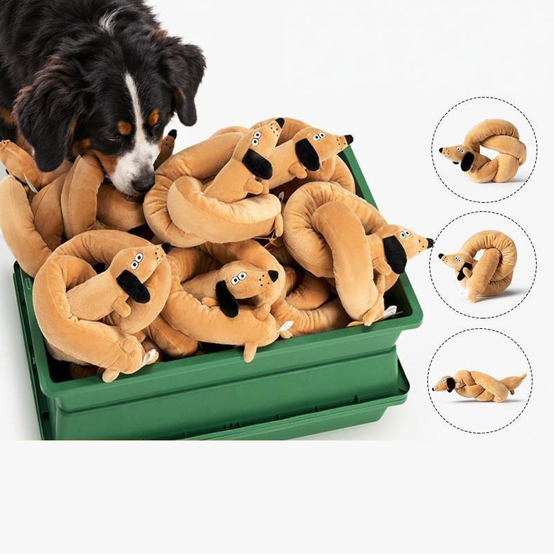 Bernese mountain dog sniffing a green crate full of long plush dog toys, with three toys bent into different shapes