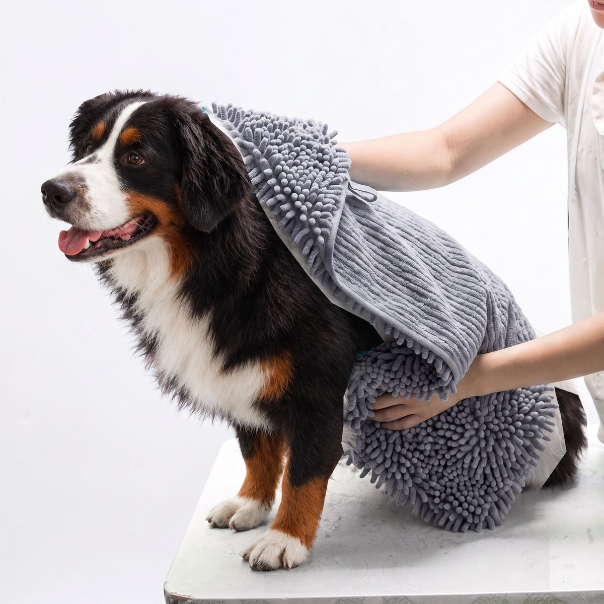 Grey chenille drying towel with hand pockets wrapped around a Bernese mountain dog