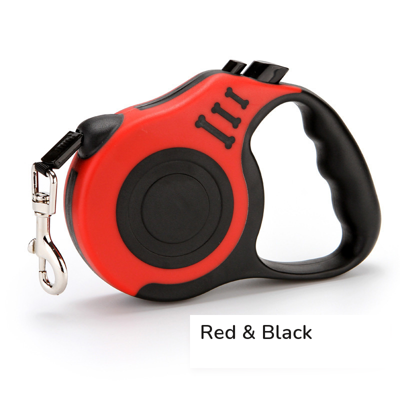 Red retractable leash with a black grip, side view on white