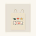 Natural canvas tote with a dog's name in printed varsity-style lettering and three small icons