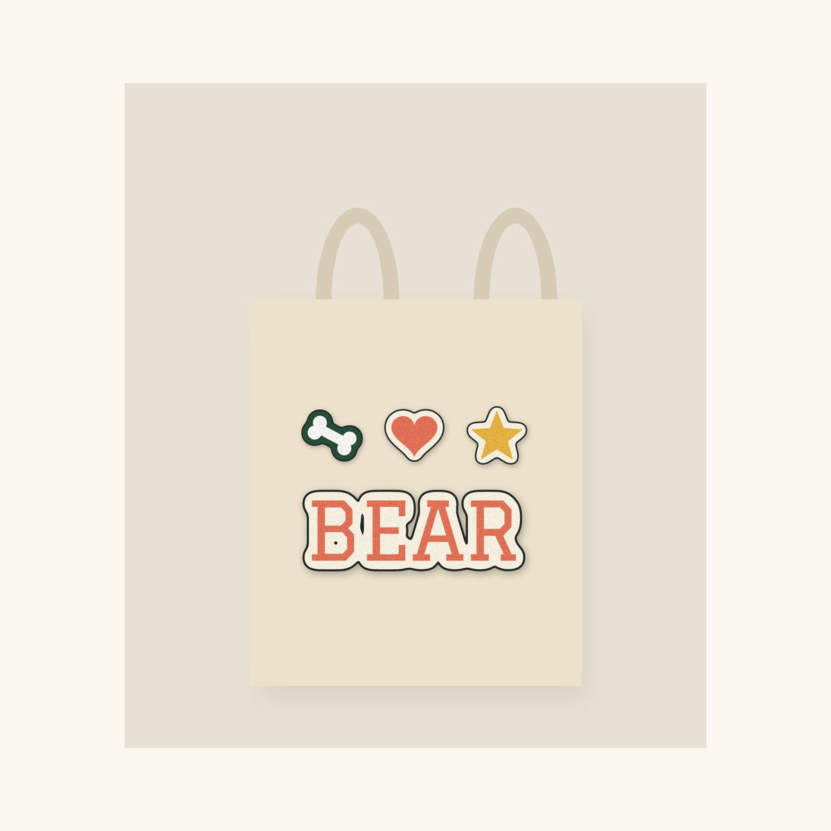 Natural canvas tote with a dog's name in printed varsity-style lettering and three small icons
