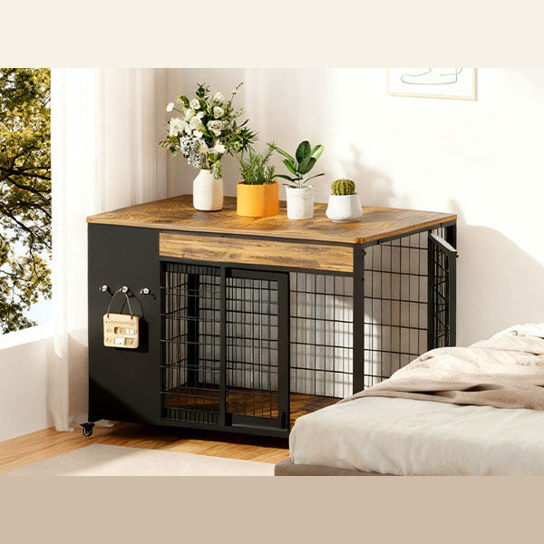 Rustic brown dog crate end table used as a nightstand beside a bed