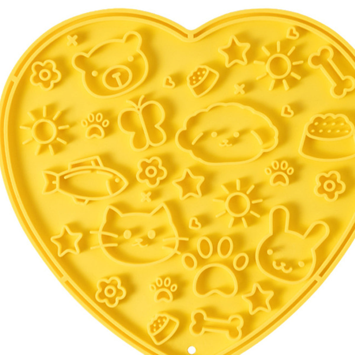 Yellow heart-shaped silicone lick mat, top view, showing the moulded animal and flower shapes