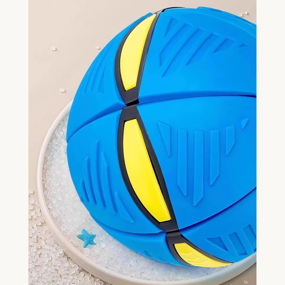 Blue flying-saucer dog ball, showing the yellow panel seams