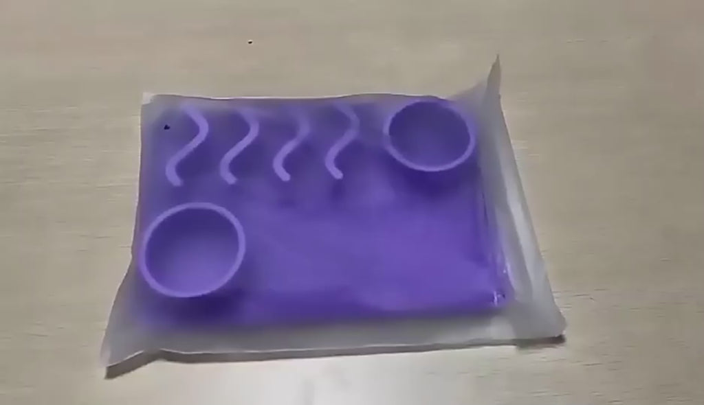 Supplier product video: the mat is unpacked and shown close up. On-screen text reads "Made of food grade silicone material", "It can hold dry food, wet food and water" and "With suction cups in the back".