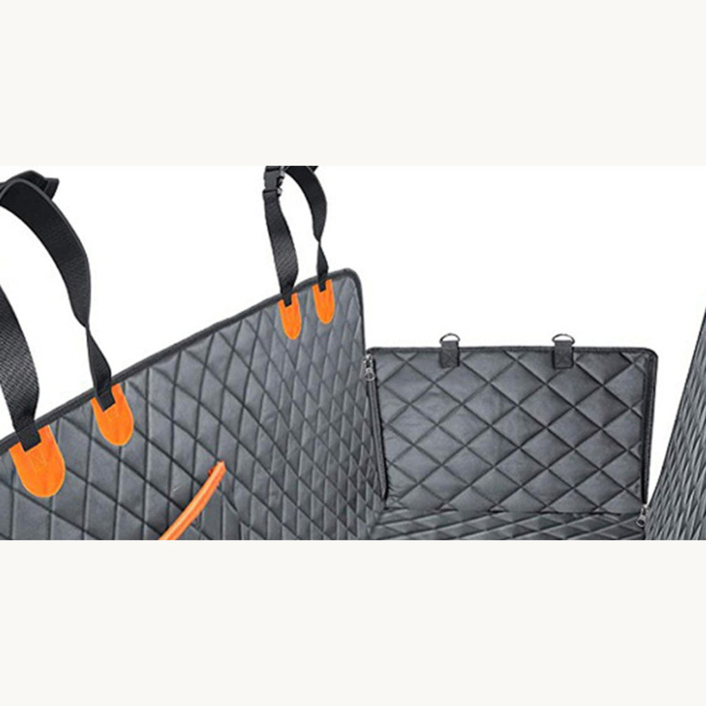 The quilted car seat cover laid out with its side flaps and orange buckle straps