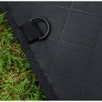 Close-up of a D-ring anchor sewn into the quilted car seat cover