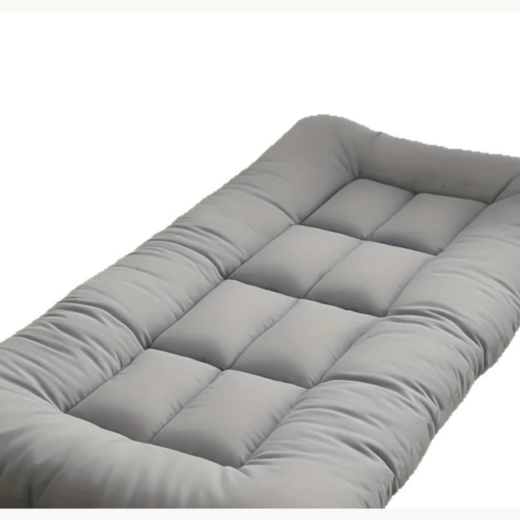 Grey quilted pet mat laid flat, three-quarter view showing the tufted squares