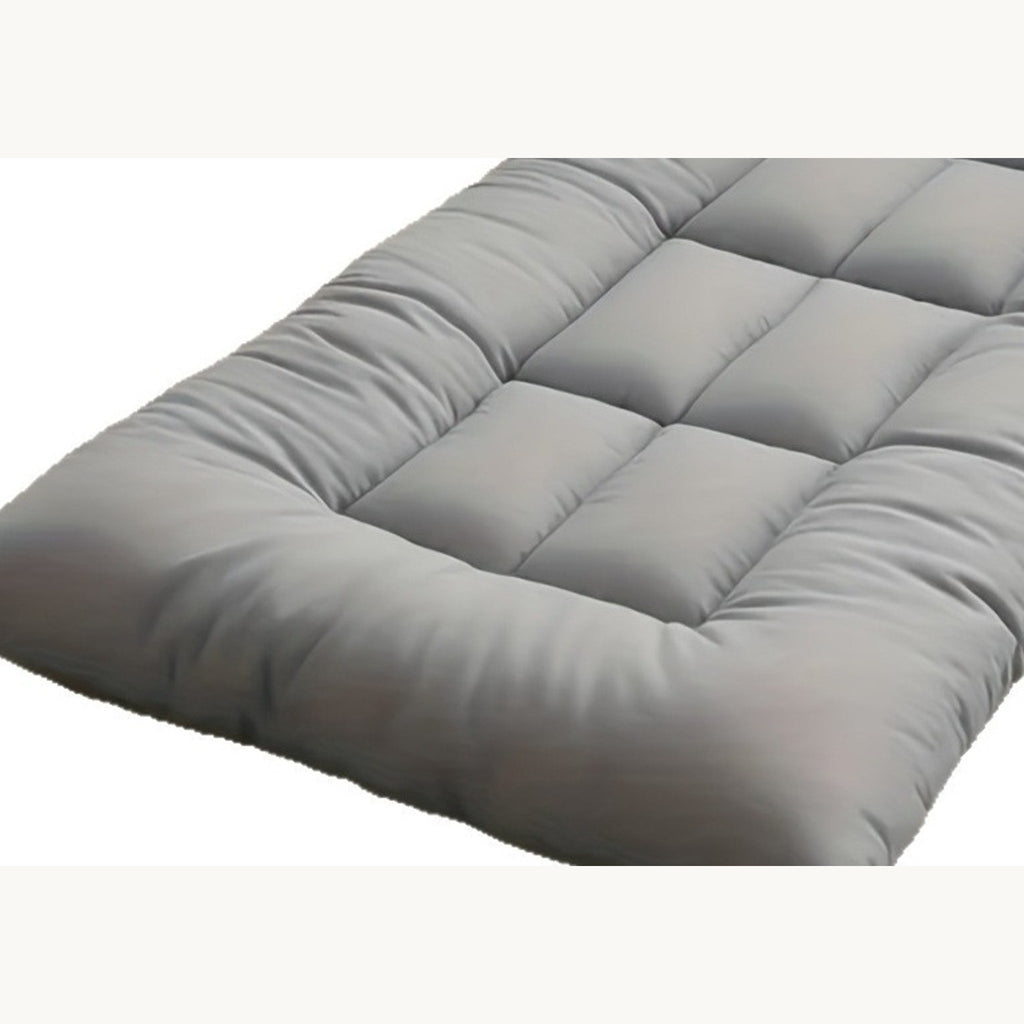 Close-up of the grey quilted pet mat, showing the tufting and the edge seam