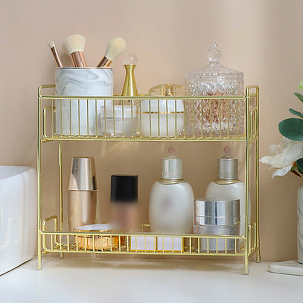 Gold 2-tier metal vanity shelf holding unbranded skincare bottles, a jar and a brush cup — Gold option