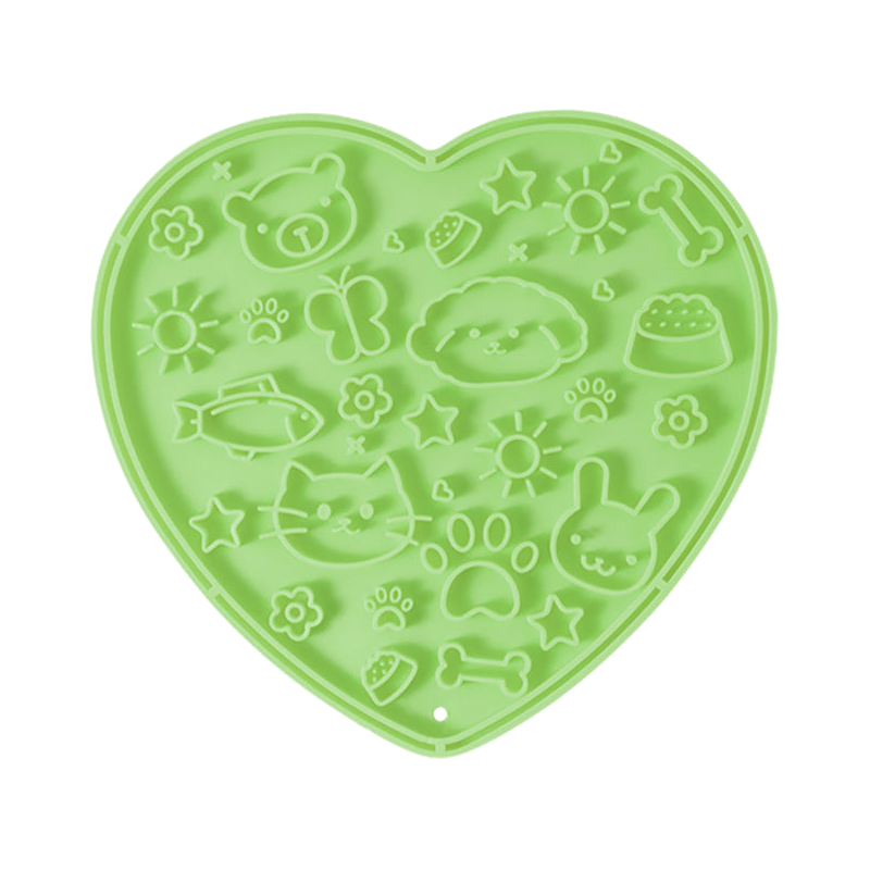 Green heart-shaped silicone lick mat, top view on a white background