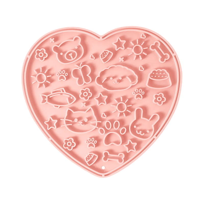 Pink heart-shaped silicone lick mat, top view on a white background