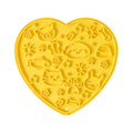 Yellow heart-shaped silicone lick mat, top view on a white background